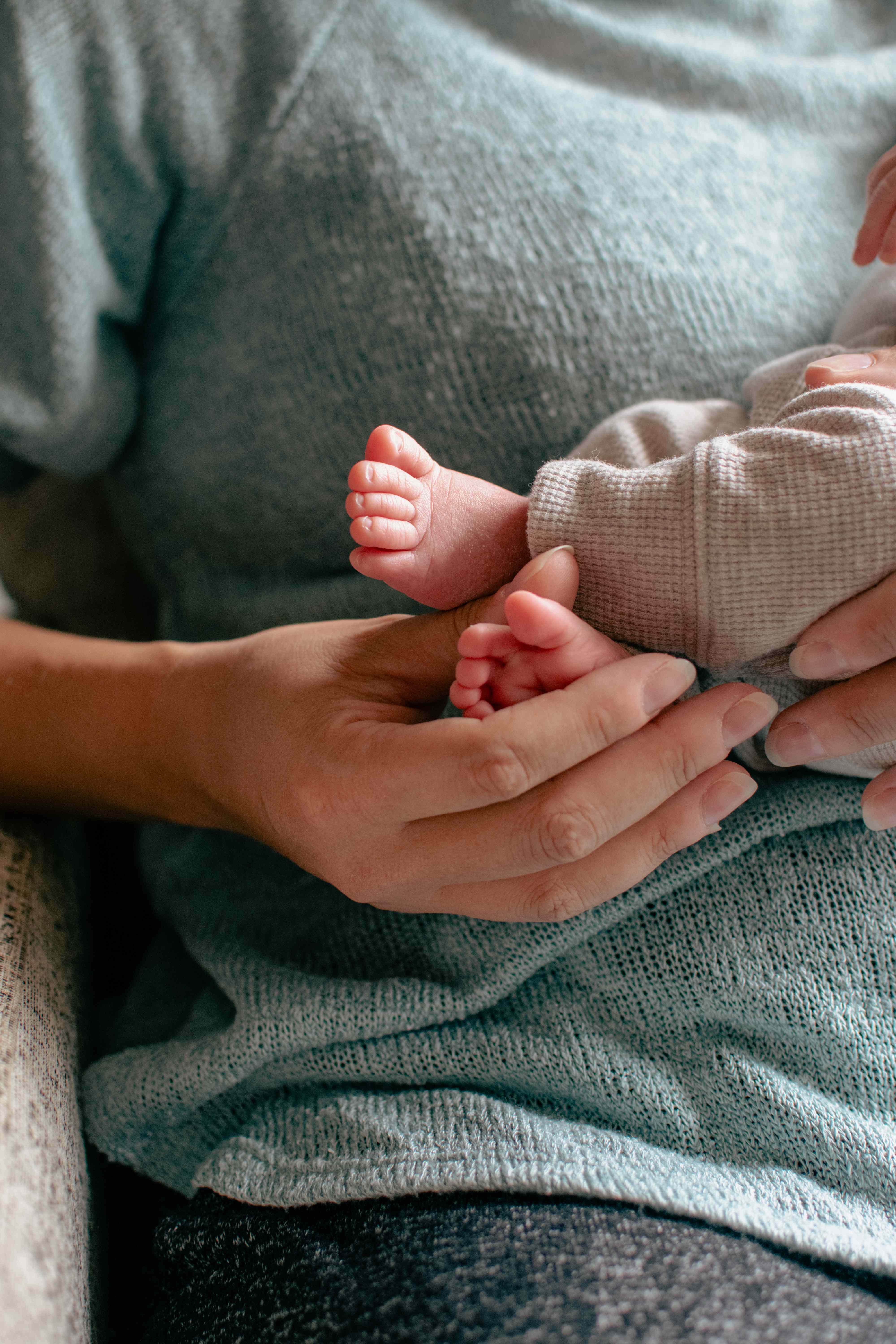 Parent holding tiny newborn feet