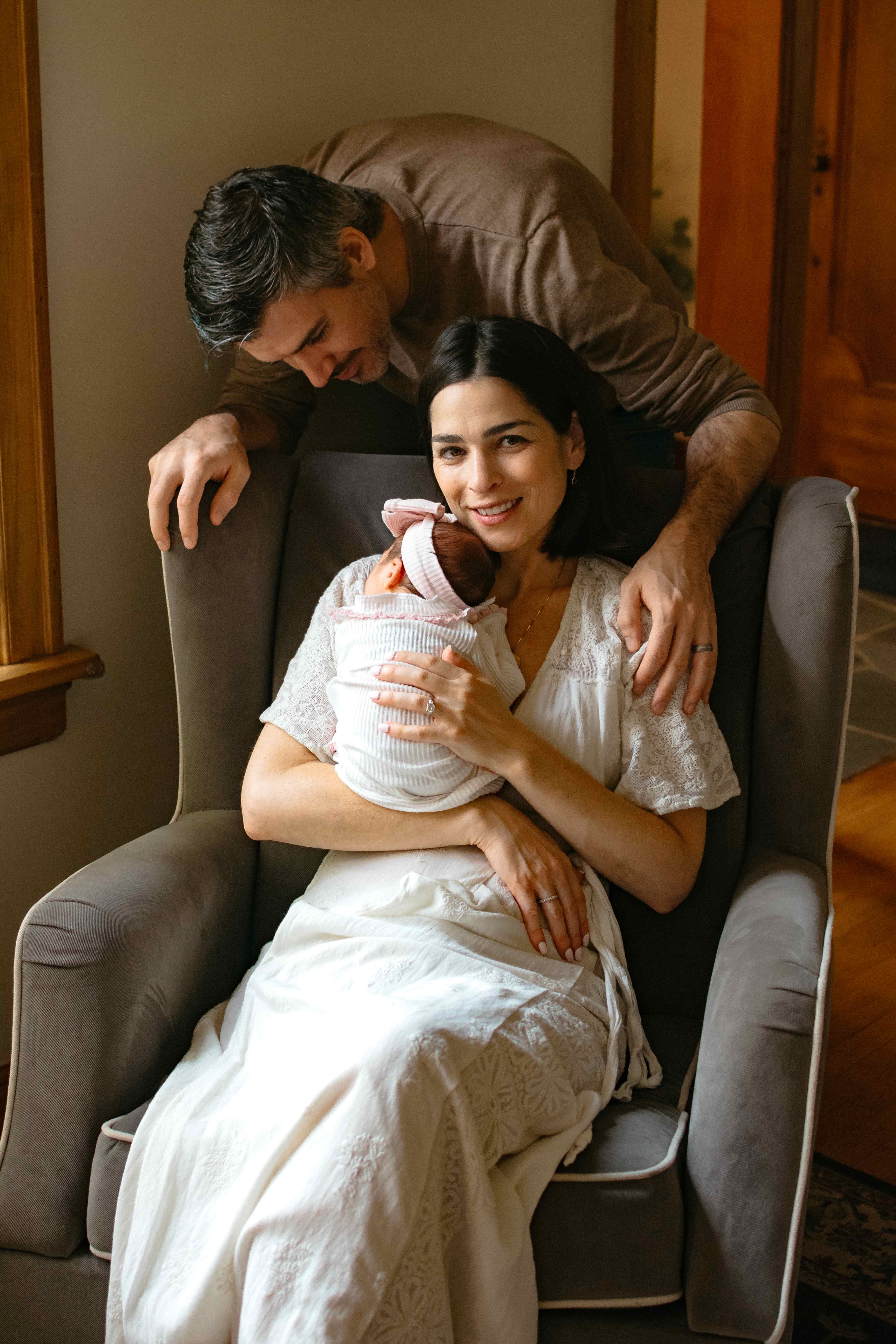 Family portrait with newborn in chair