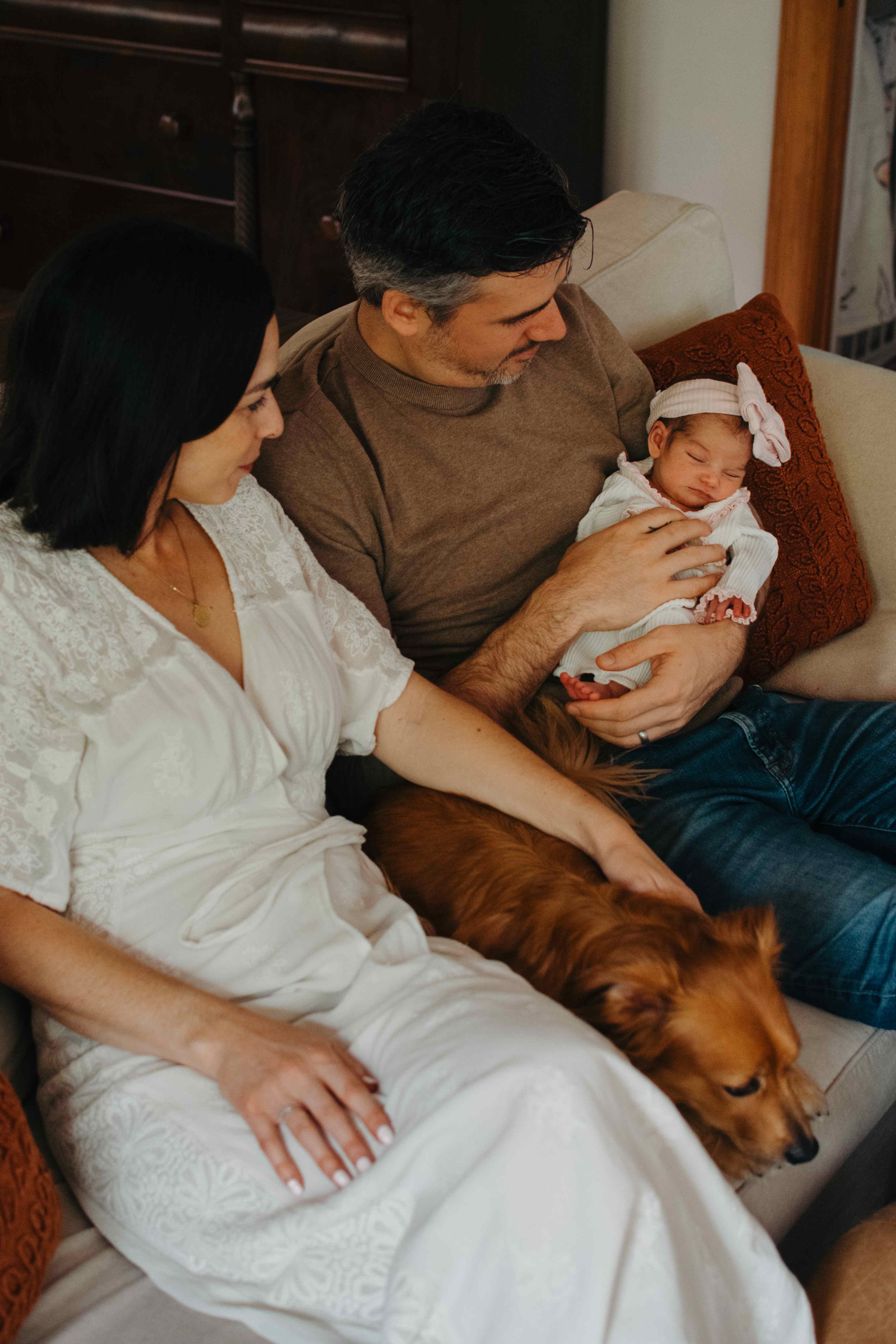 Family with newborn and golden retriever